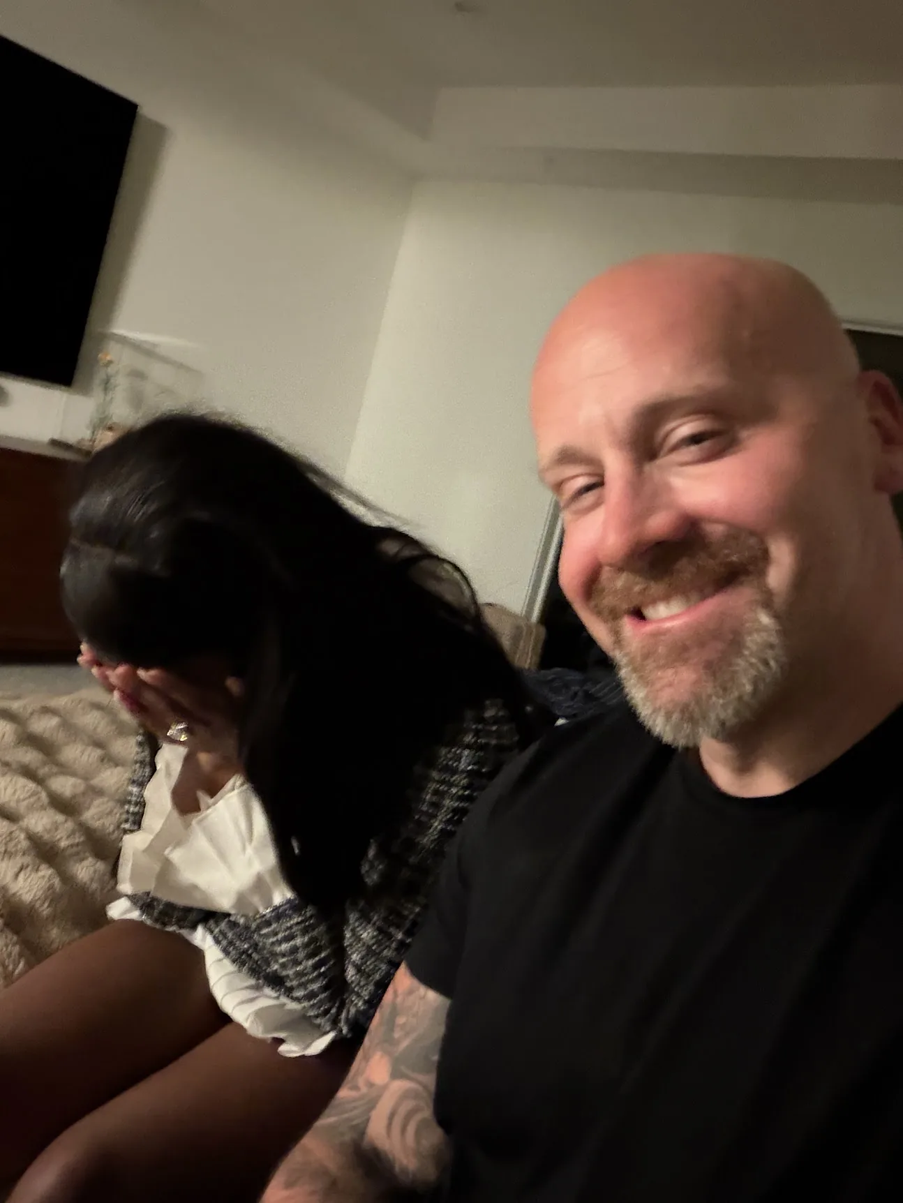 Candid photo of Joe and Ashly during the private proposal at home.