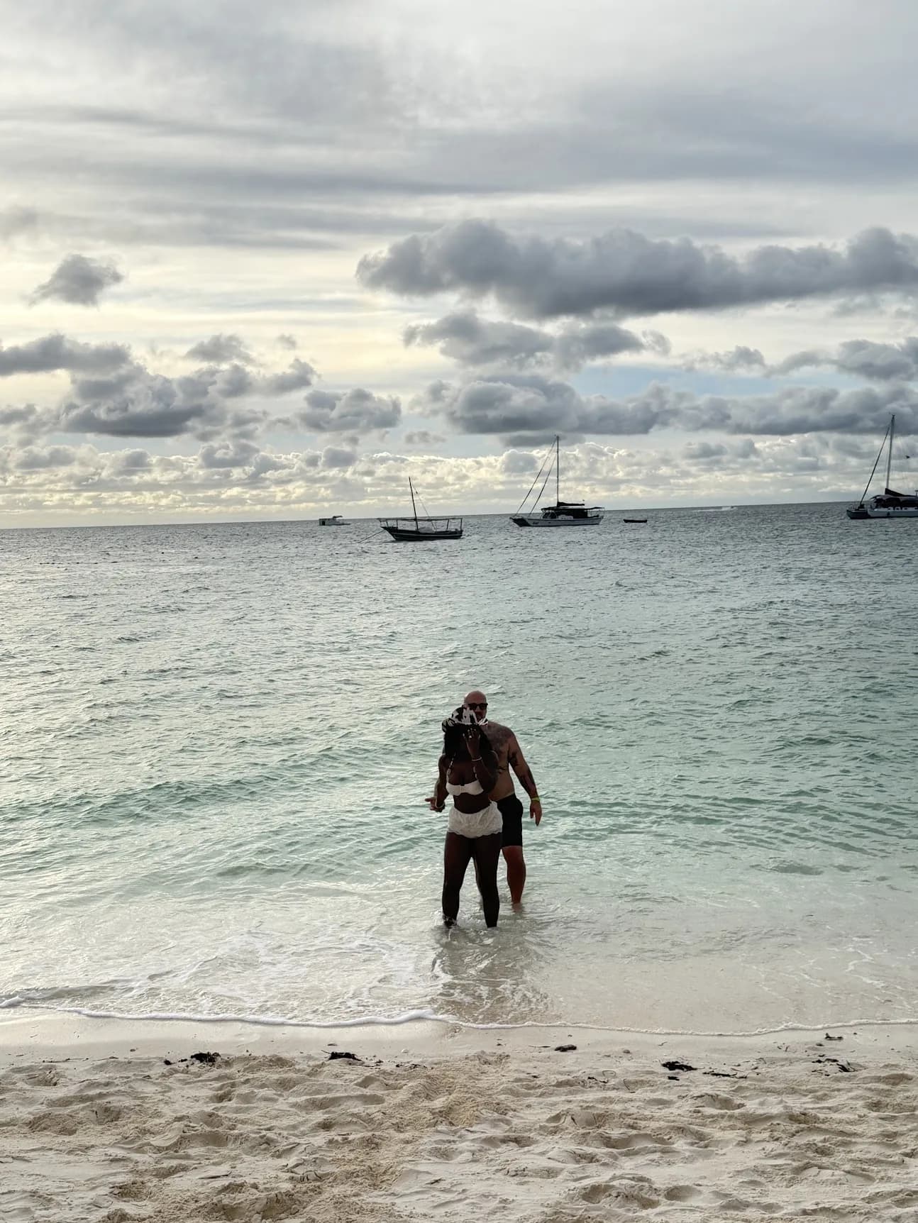 One of the last photos of Joe and Ashly together, on the beach in Zanzibar, with Ashly displaying the ring.
